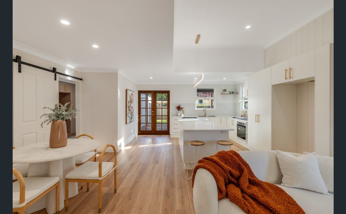Completed Toowoomba City renovation showing open-plan kitchen and living area with feature pendant lighting and downlights