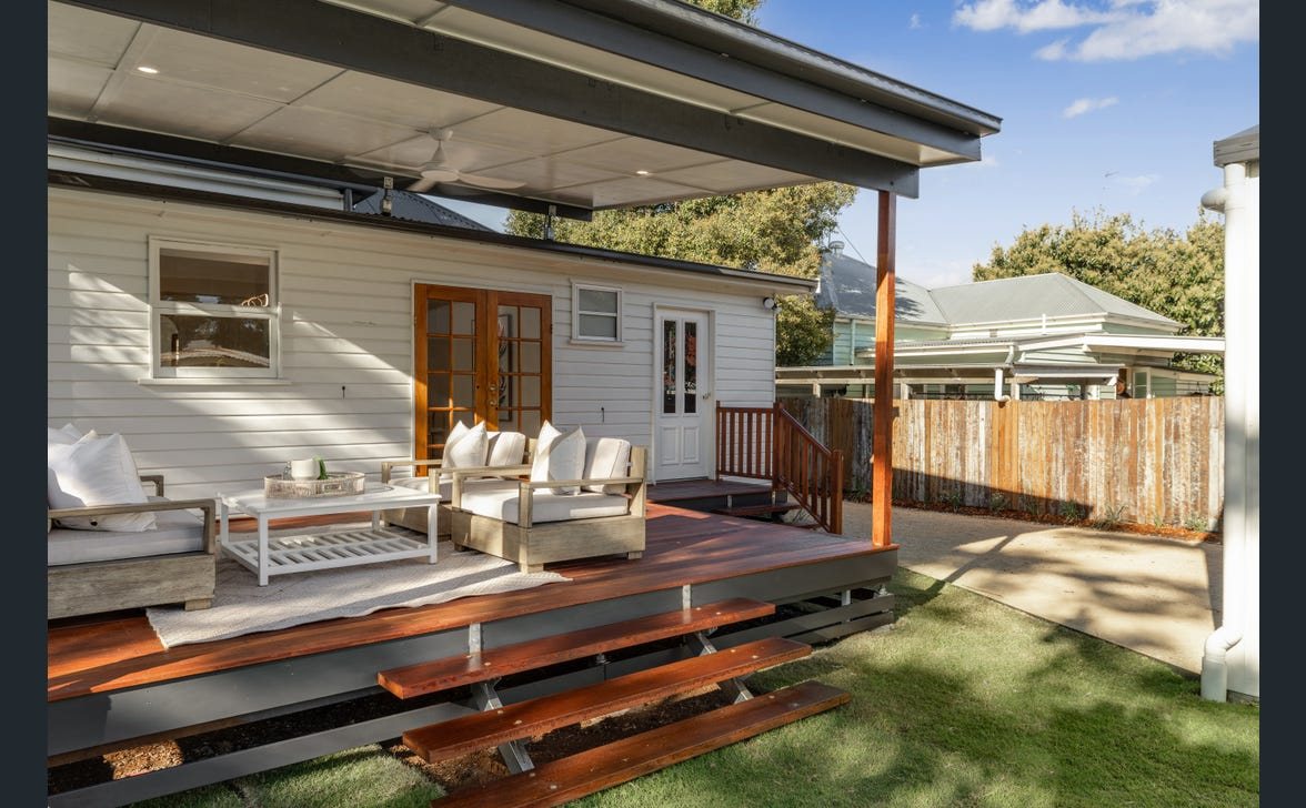 Covered outdoor entertaining area with ceiling fan and recessed lighting